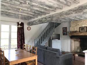a living room with a couch and a table at Gîte du Bouloy in Montru