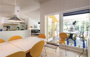 a kitchen and dining room with a table and chairs at Duen in Vester Sømarken