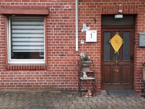 a brick building with a door and a sign on it at One-bed room Mariensee in Neustadt am Rübenberge