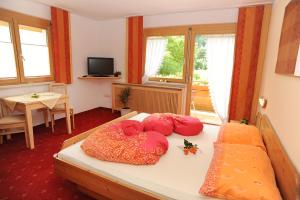 a bedroom with a bed with pillows on it at Pension Rudigier Appartements in Sankt Gallenkirch