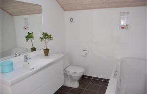 a bathroom with a sink and a toilet and a tub at Holiday Home Kongsnæsparken Stubbekøbing I in Stubbekøbing