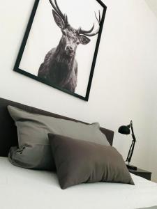 a picture of a deer on a wall above a bed at Danilos Boardinghouse in Weinheim