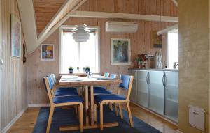 a kitchen with a table and chairs and a refrigerator at Beautiful Home In Fan With Sauna in Fanø