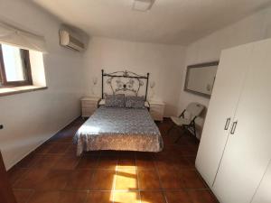 a bedroom with a bed and a tiled floor at Villa Solojog23 in Arriate