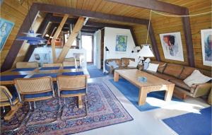 a living room with a couch and a table at Holiday Home Golfsvinget in Gatten