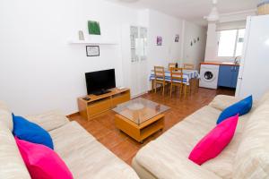 a living room with a couch and a table at Casa Piedra Picuda 1 in Mogán