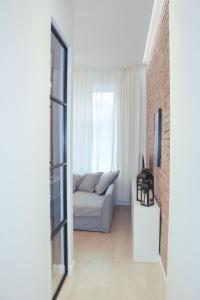 a living room with a couch and a window at Apartament Andersa in Sopot