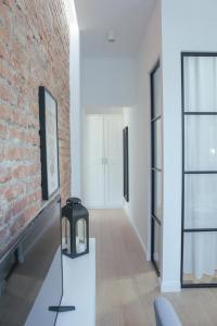 a living room with a brick wall and a fireplace at Apartament Andersa in Sopot