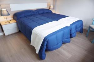 a blue and white bed in a room at Casa La Solana in Bolaños de Campos