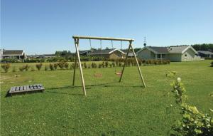 a swing set and a bench in a yard at Holiday Home Strandparken in Otterup +14 photos