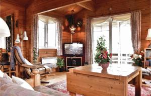 a living room with a couch and a table at Beautiful Home In Ringkbing With 3 Bedrooms, Sauna And Wifi in Klegod