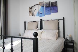 a bedroom with a black bed with two pillows at Joyas cosy apartment in Tragaki