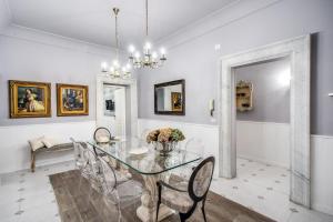 罗马Ripetta Miracle Suite的配有玻璃桌椅的餐厅