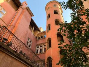 a large brick building with a clock tower at Gîte du Vieux Lyon in Lyon