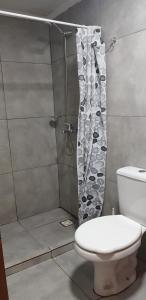 a bathroom with a shower with a toilet and a shower curtain at Pacurí - Habitaciones Privadas in Puerto Iguazú +44 photos