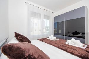 a bedroom with two beds and a large window at Apartment Laura in Privlaka +106 photos