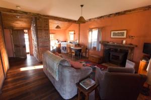 a living room with a couch and a fireplace at Brickendon in Longford