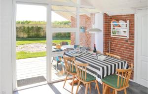 a dining room with a table and some chairs at Three-Bedroom Holiday Home In Hadsund in Haslevgårde