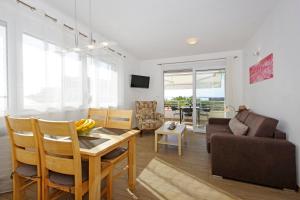 a kitchen and living room with a table and a couch at Apartment Laura in Privlaka