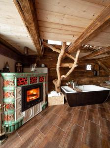 a bathroom with a fireplace and a tub and a sink at Romantische Hütte in Ramsau