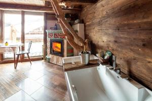 a living room with a fireplace and a stove at Romantische Hütte in Ramsau