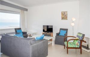 a living room with two couches and a table at Residentie Emeraude 4D in Ostend