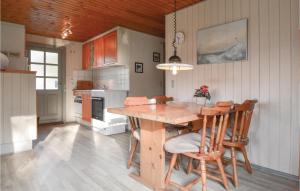 a kitchen with a wooden table and chairs at Stunning Home In Hemmet With 3 Bedrooms And Wifi in Hemmet