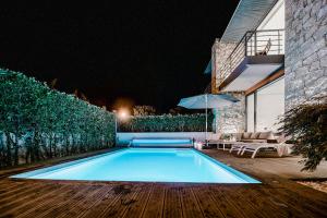 a swimming pool in the backyard of a house at night at Casa Reserva do Poeta in Viana do Castelo