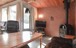 a living room with a wooden table and a wood stove at Stunning Home In Hemmet With 3 Bedrooms And Wifi in Hemmet
