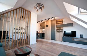 a living room with a staircase and a dining room at Apartment City View in Sofia