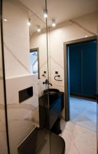 a bathroom with a black sink and a glass shower at Apartment City View in Sofia