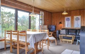a living room with a table and chairs and a couch at Holiday Home Arvidvej Denmk Xii in Bjerregård