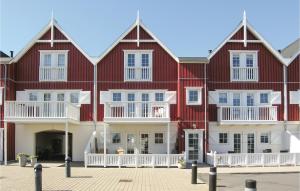 a large red building with white windows and balconies at Three-Bedroom Apartment In Bagenkop in Bagenkop