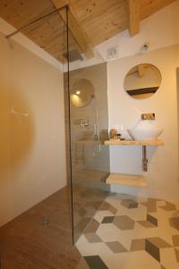 a bathroom with a glass shower and a sink at Torre's Camere & caffè in Monreale
