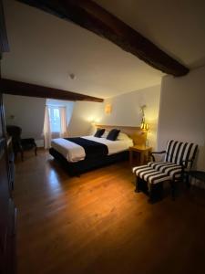 a bedroom with a king sized bed and a chair at Chambres D'Hotes Rekko in Maastricht