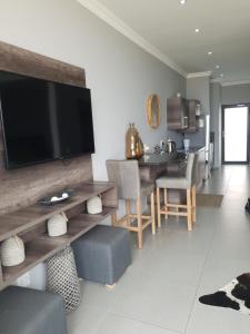 a living room with a television on a wall at Bayview Suites, Unit 9, Room # 13 in Langstrand
