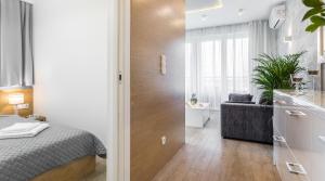 1 Schlafzimmer mit einem Bett und einem Bad in der Unterkunft Ariańska 6 Apartments by LET'S KRAKOW in Krakau
