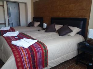 Postel nebo postele na pokoji v ubytování Hostal Jerian