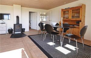 a dining room with a table and chairs and a stove at Ven Havnehotel in Struer