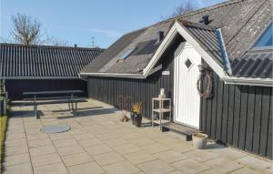 a black shed with a picnic table and a bench at Amazing Home In Storvorde With 2 Bedrooms And Wifi in Egense