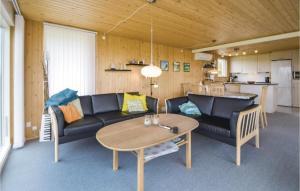 a living room with a couch and a table at Three-Bedroom Holiday Home In Knebel in Knebel +19 photos