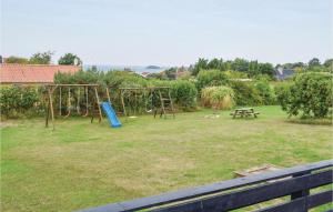 a park with a swing set and a picnic table at Three-Bedroom Holiday Home In Knebel in Knebel