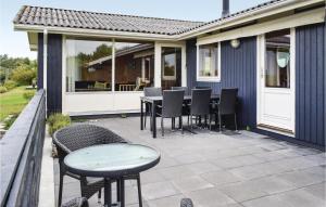 a patio with chairs and a table on a house at Three-Bedroom Holiday Home In Knebel in Knebel