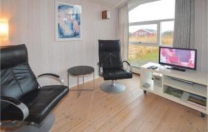 a living room with two chairs and a television at 3 Bedroom Pet Friendly Home In Hirtshals in Hirtshals