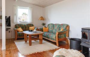 a living room with a couch and a table at Lovely Home In Kalundborg With Kitchen in Bjørnstrup