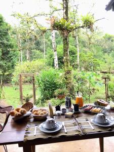帕拉蒂的住宿－Sitio Namaste Paraty，一张木桌,上面有面包和其他食物