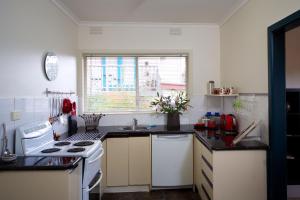 a kitchen with a stove top oven and a window at Healesville Apartments in Healesville