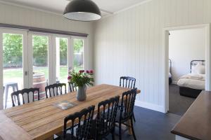 a dining room with a wooden table and chairs at The Manse on Ebden in Kyneton