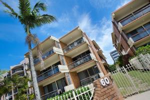 a building with a palm tree in front of it at Riverview Two Apartments in Mooloolaba