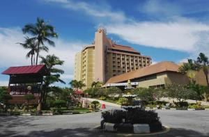 a large building with a street in front of it at Primula Beach Hotel in Kuala Terengganu
